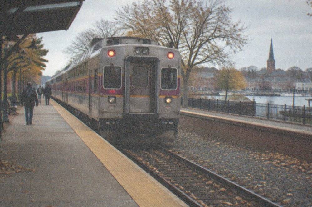 Commuter rail train at a suburban station platform in autumn
