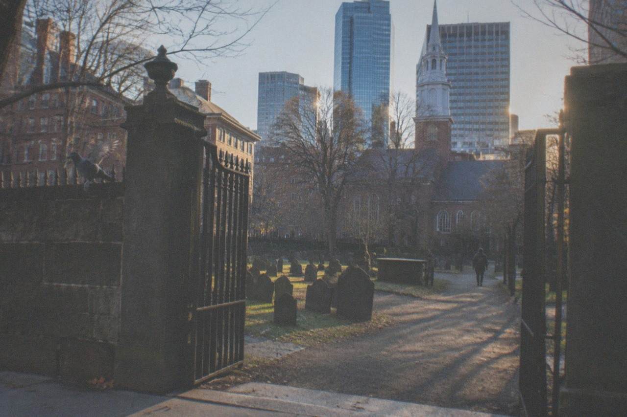King's Chapel Burying Ground with weathered gravestones and the city skyline behind