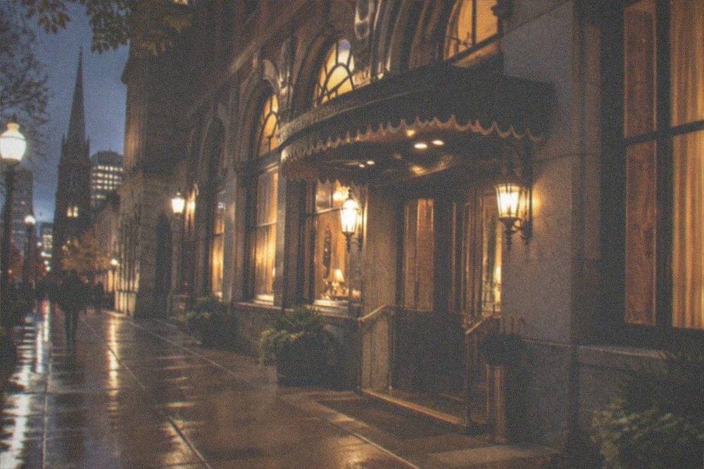 Nighttime view of the Omni Parker House hotel facade on School Street in Boston