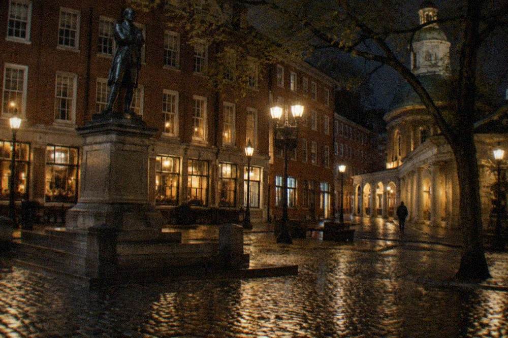 Night view of a historic Boston street with glowing pub windows and brick facades