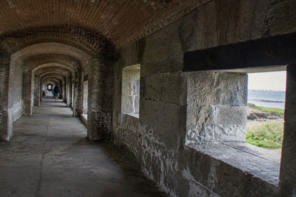 Granite casemate corridor inside a Civil War fort with arched doorways