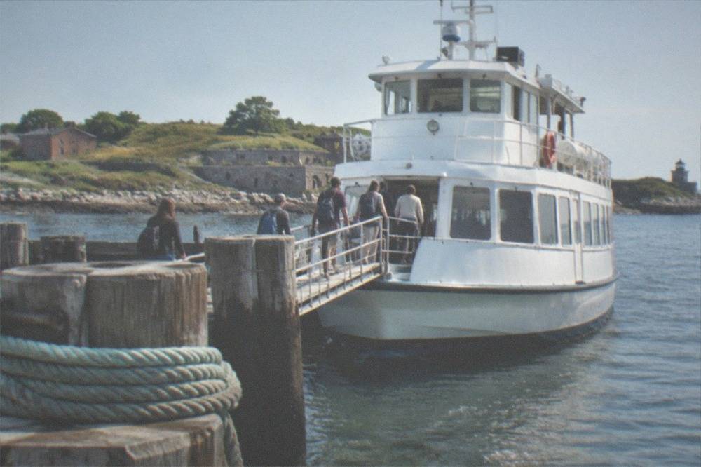 Passenger ferry at a wooden pier on a New England waterfront